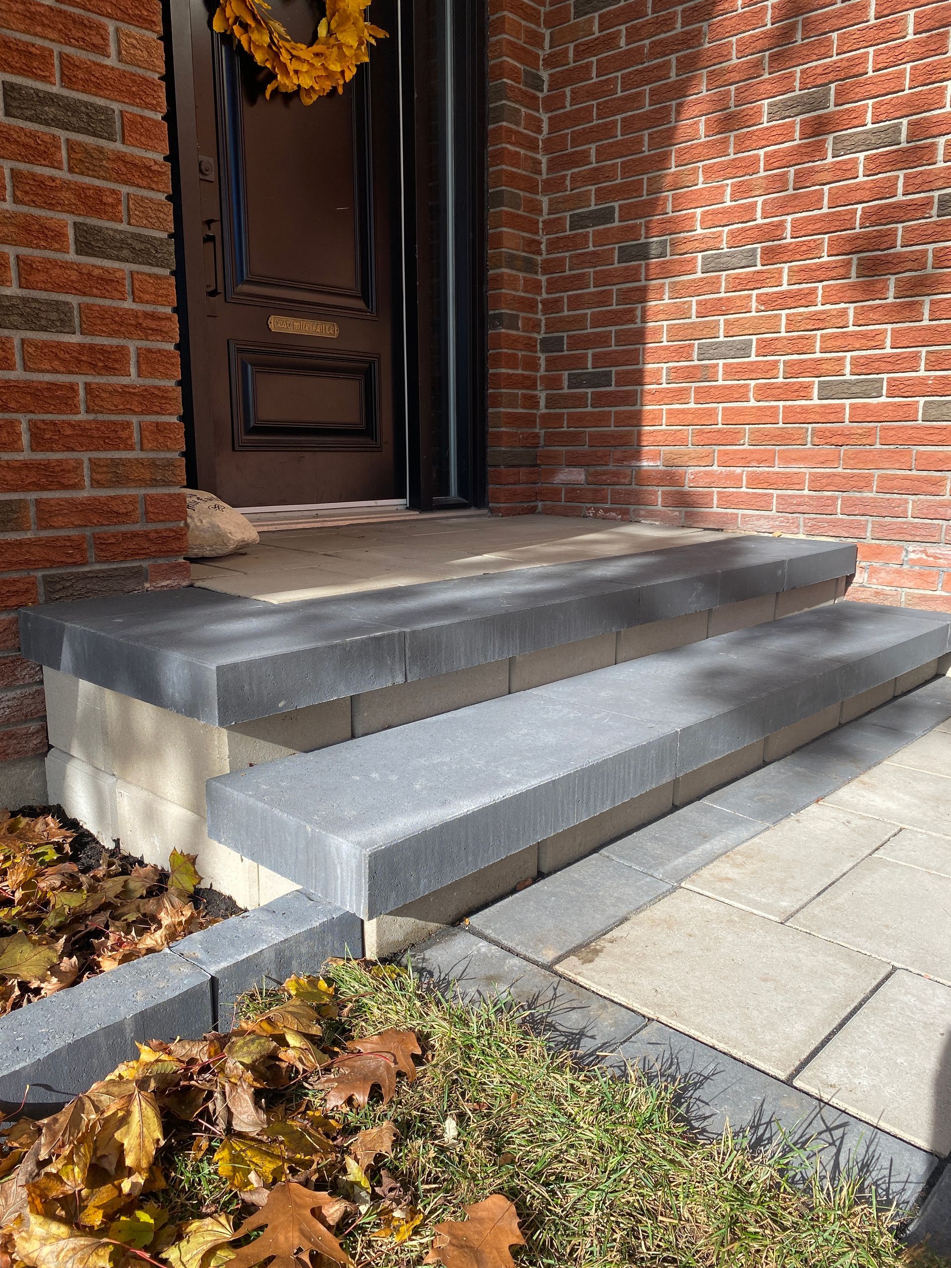the front door of a brick house has a wreath on it