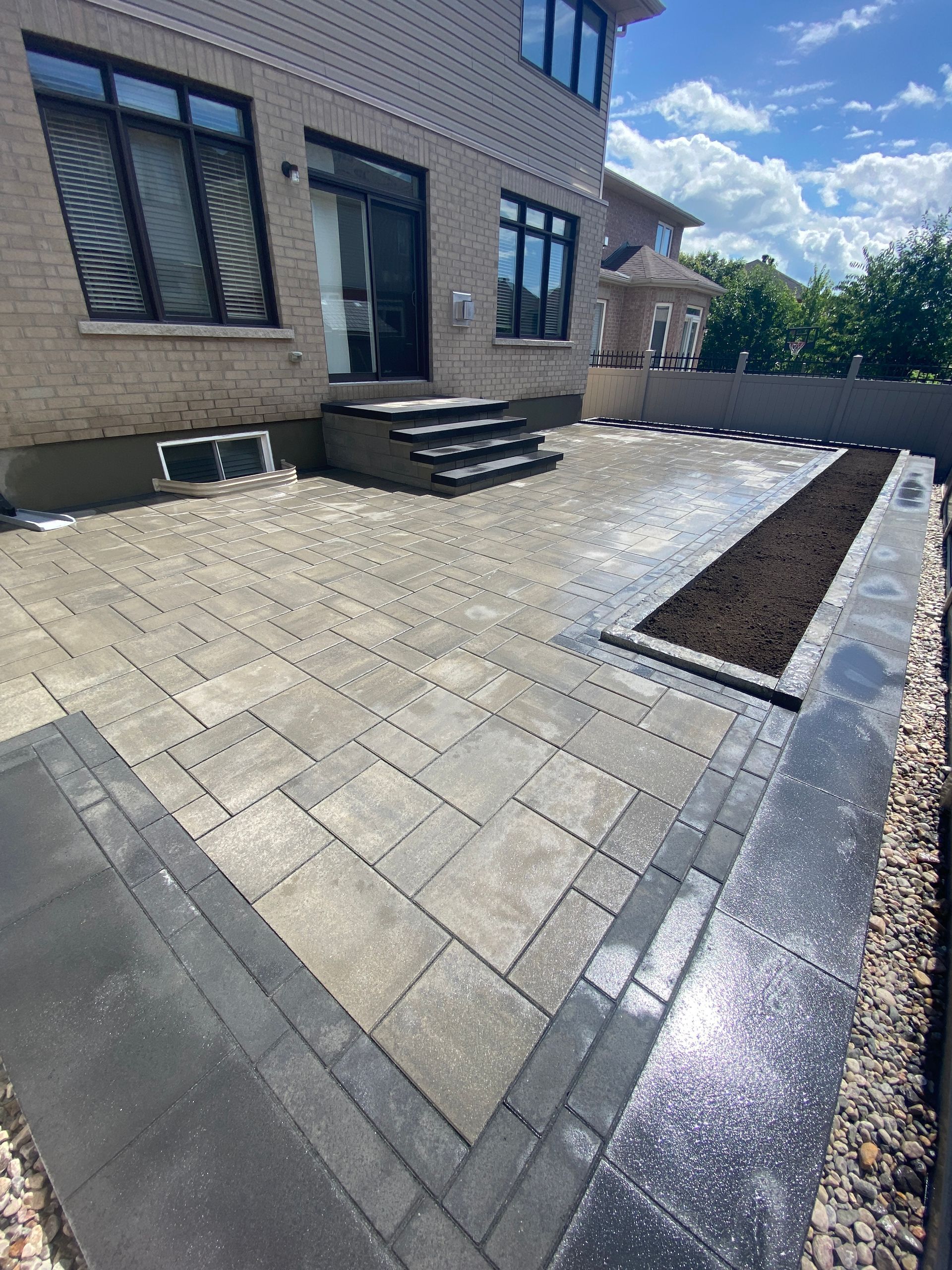 a brick house with a patio in front of it