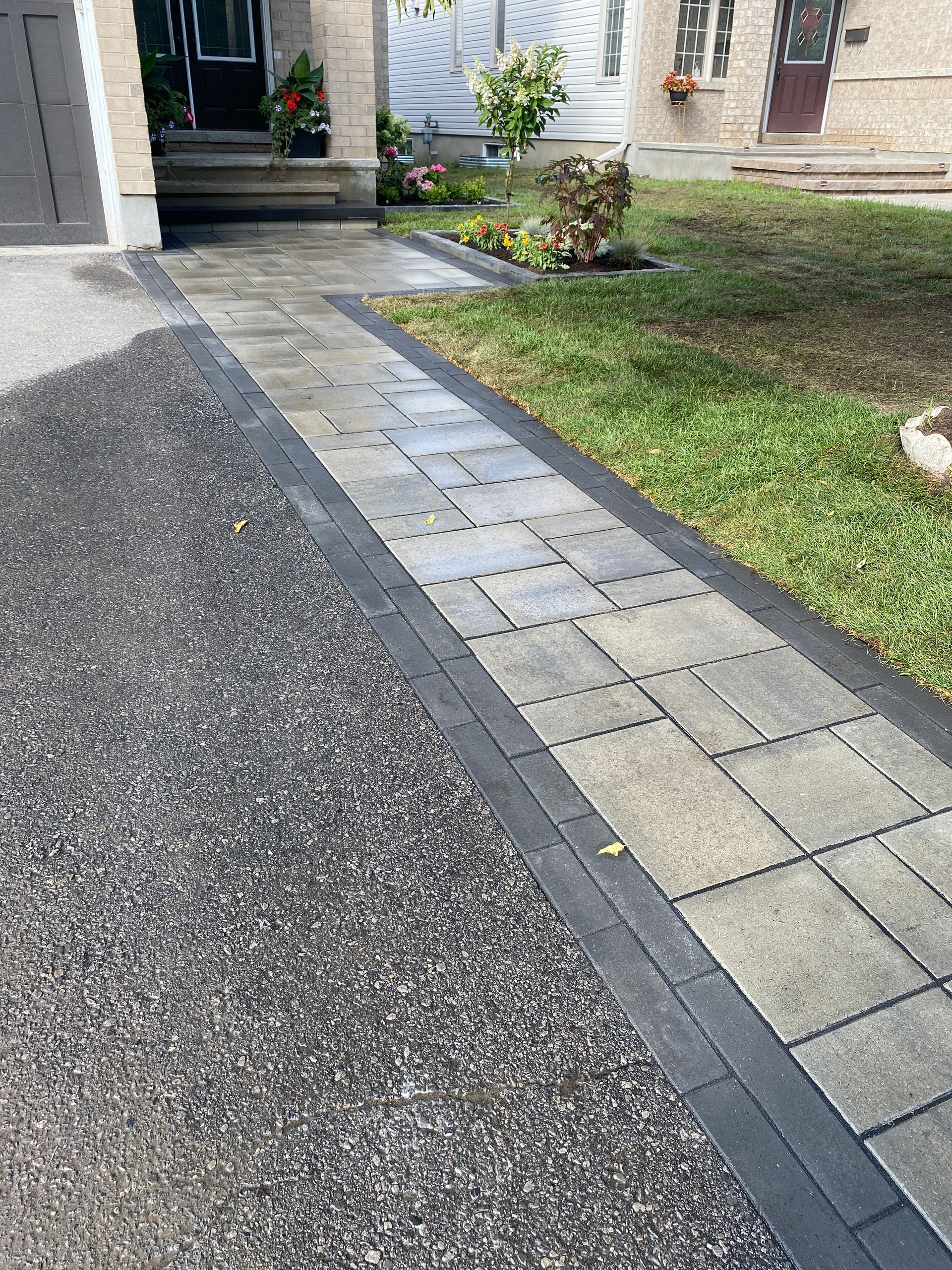 a brick walkway leading to the front door of a house