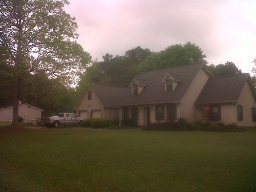 A house with a truck parked in front of it