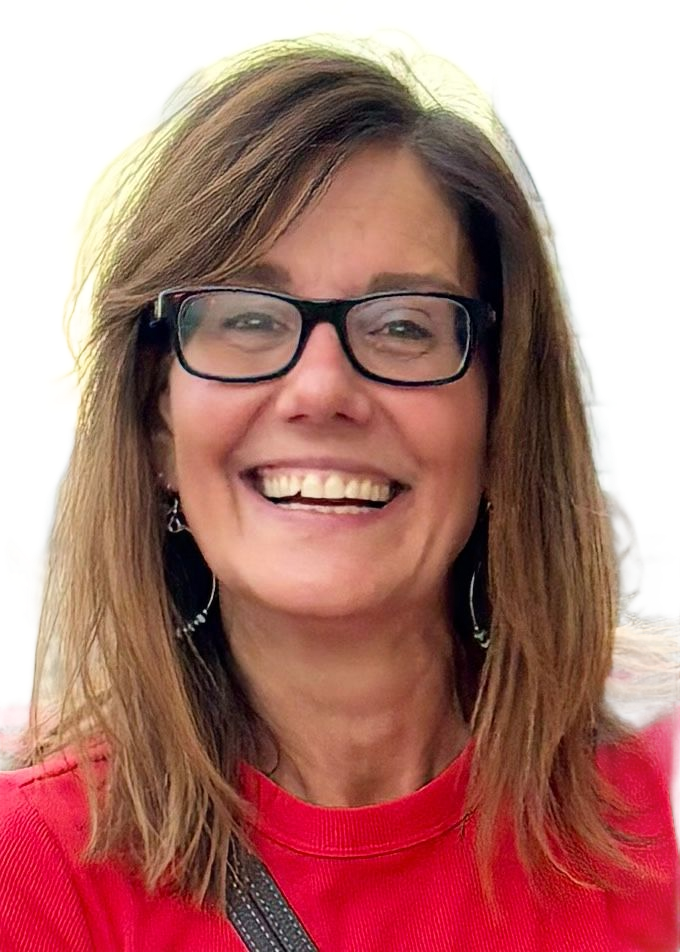 A woman in a black shirt is smiling for the camera.