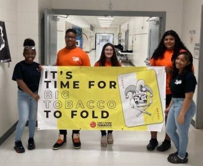 ADAPT students holding a sign that reads