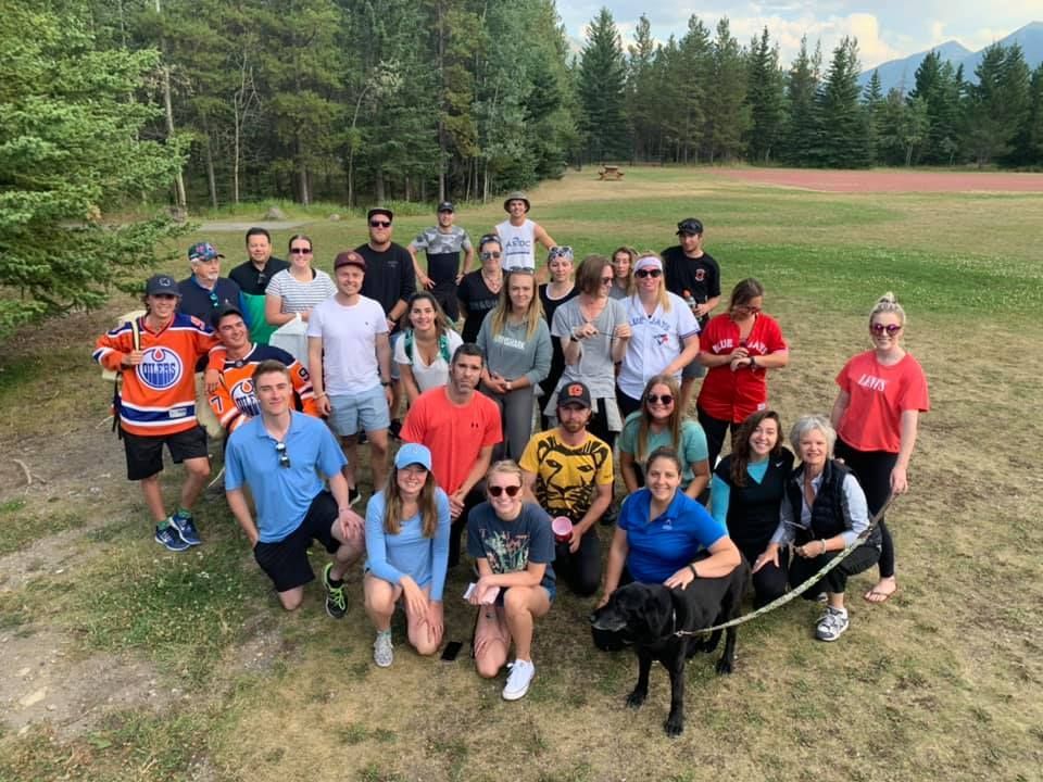 A group of people are posing for a picture in a field.