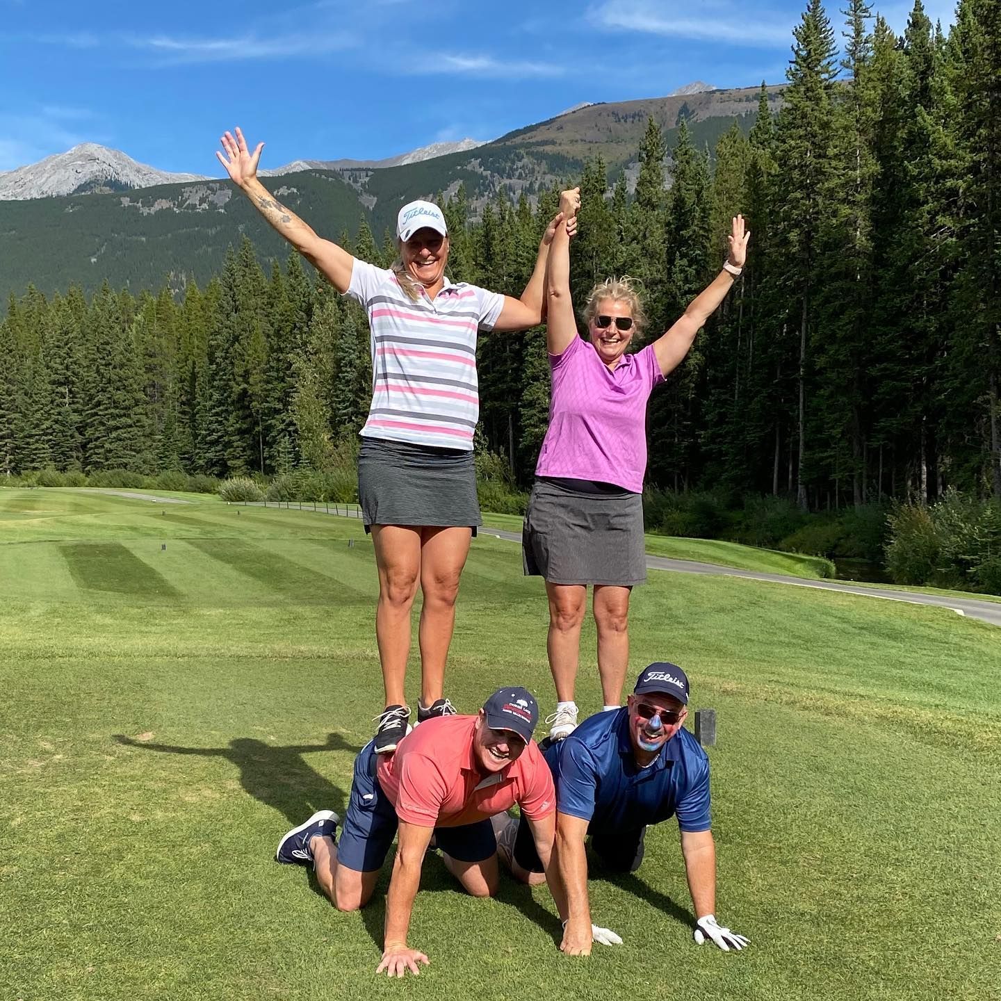 A group of people are posing for a picture on a golf course.