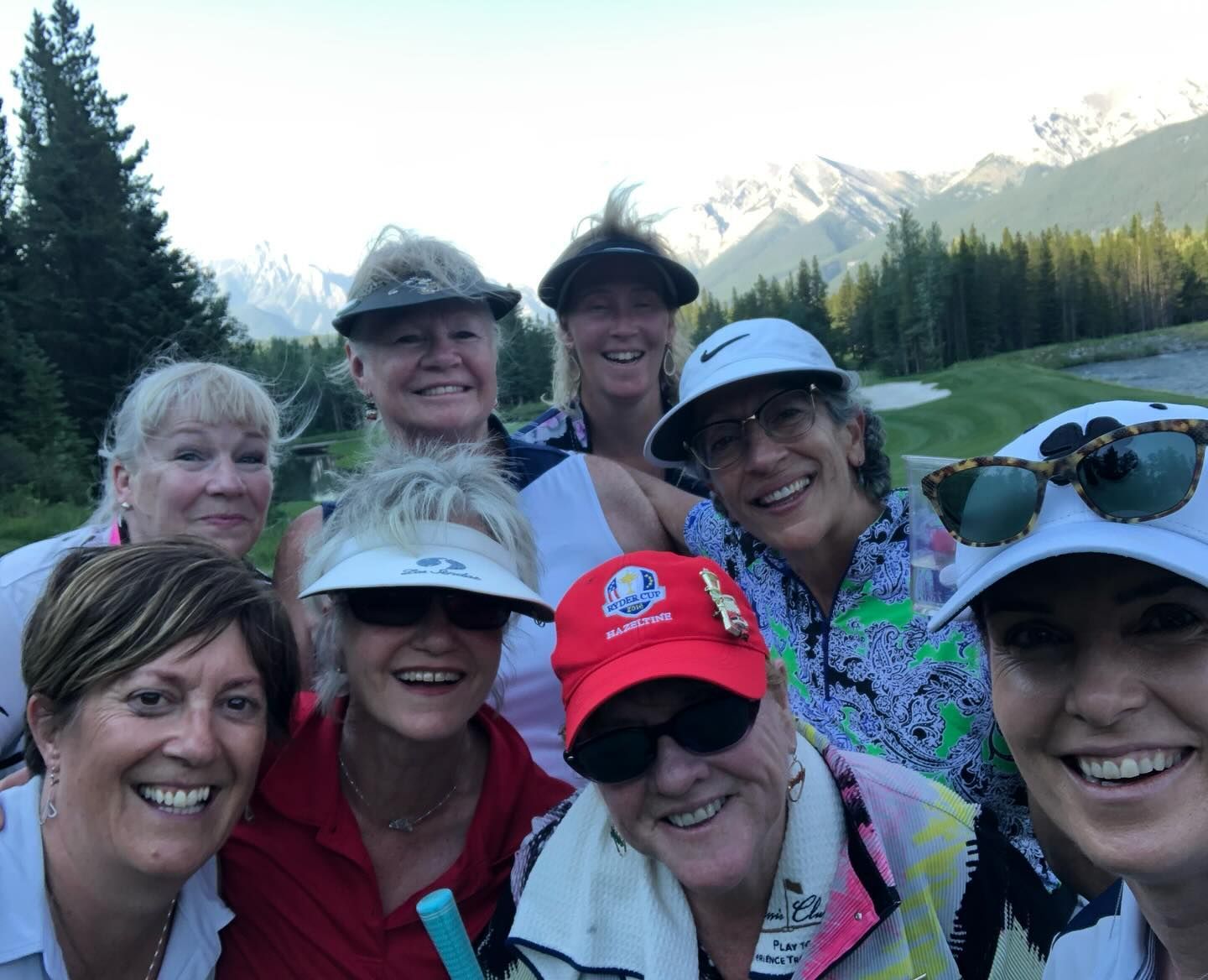 A group of women are posing for a picture on a golf course