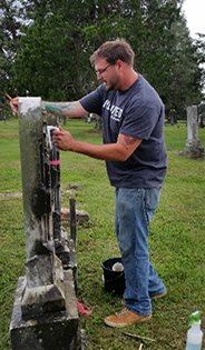 Syntelligent employee Adam Burner cleaning at cemetery