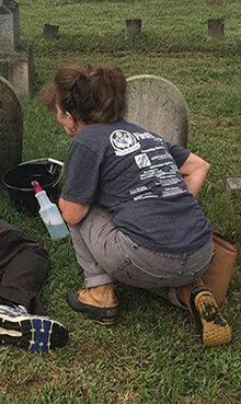 Syntelligent employee Rose Ann Smythe cleaning at cemetery