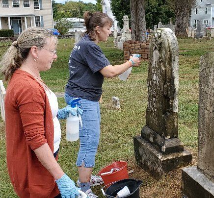 Syntelligent employees scrubbing tombstone