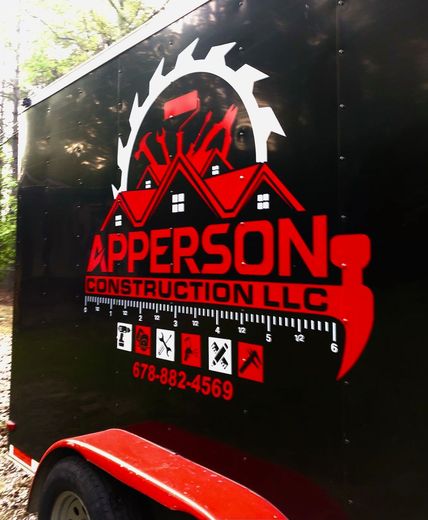 A black trailer with apperson construction llc written on it