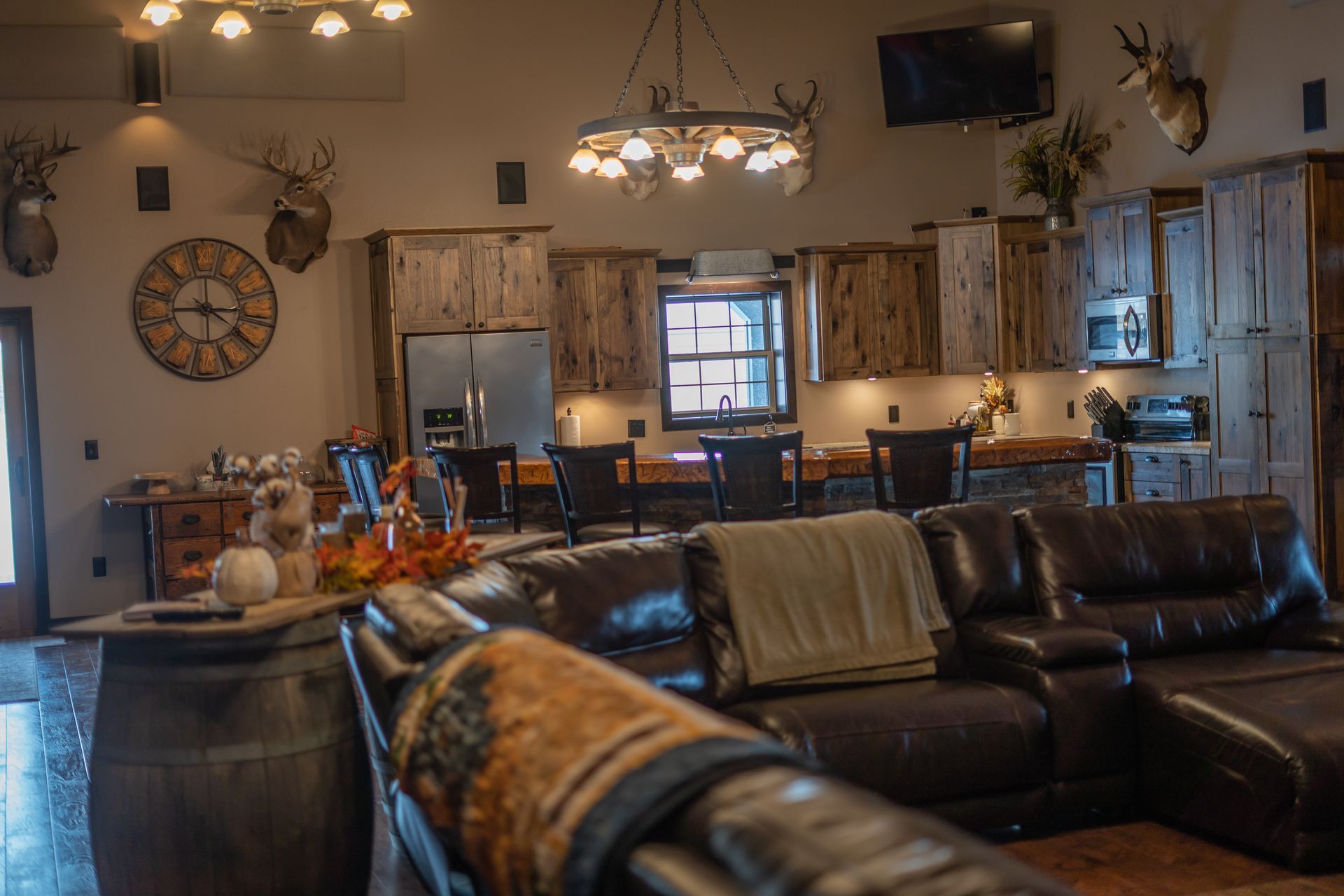 A living room filled with furniture and a kitchen in a house.
