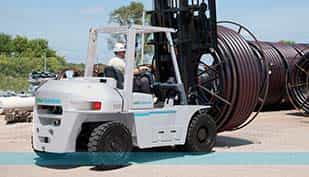 Forklifts — Worker Driving A White Forklift Lifting A Rolled Wires In Manorville, NY