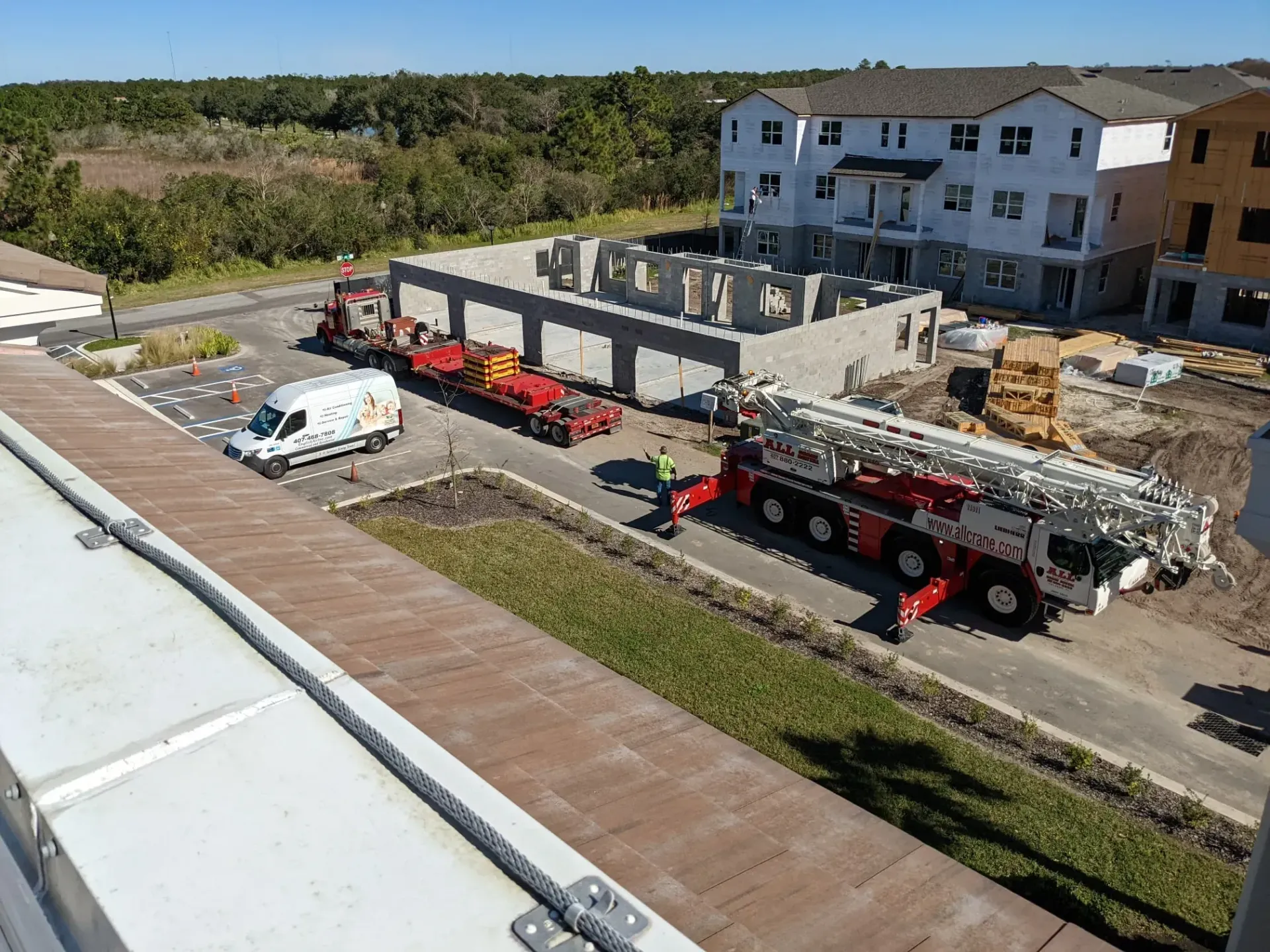 An aerial view of a construction site with a truck and a crane.