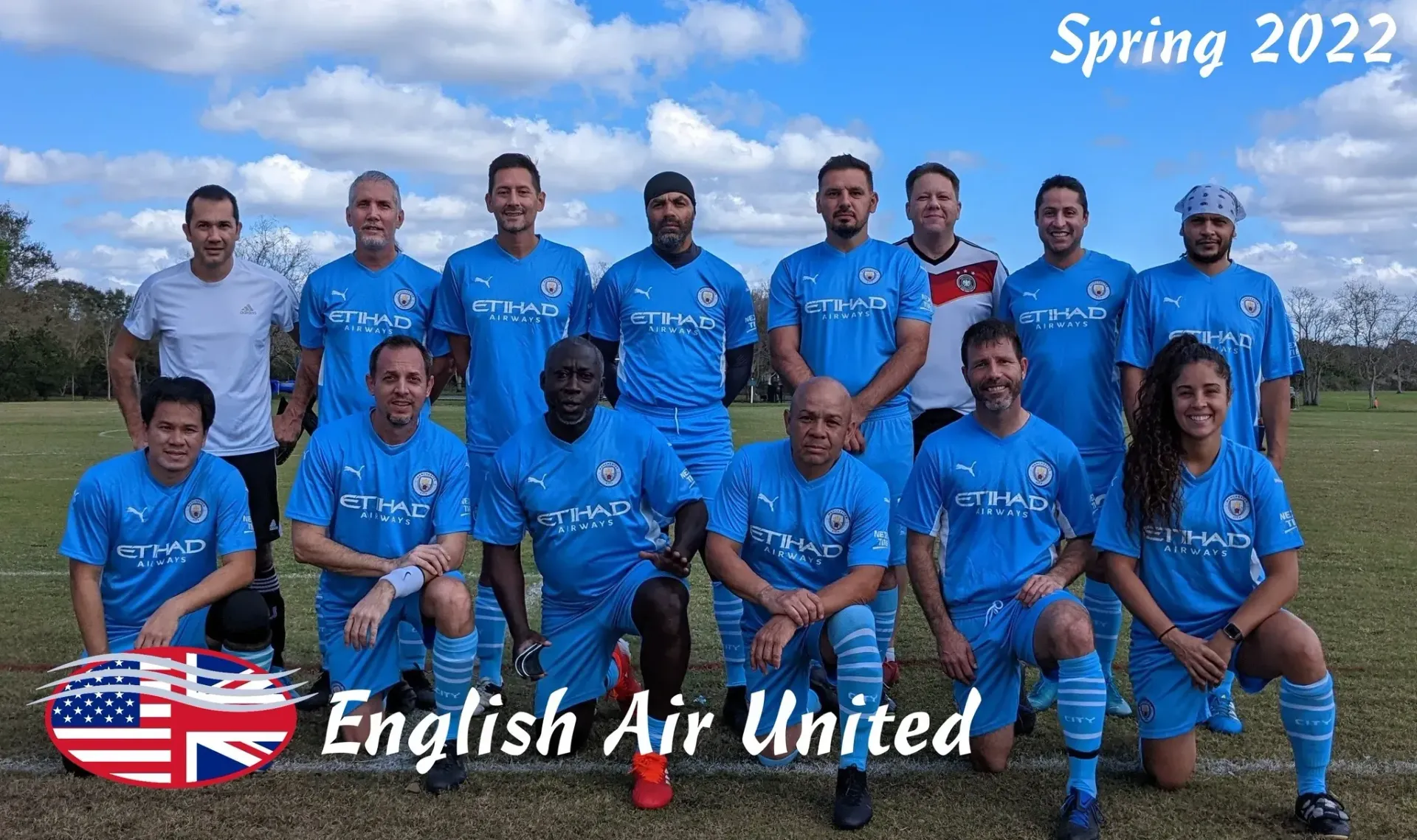 A group of soccer players are posing for a picture on a field.