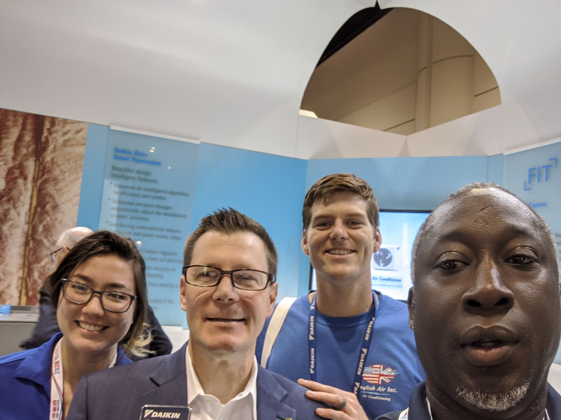 A group of people are posing for a picture in a room.