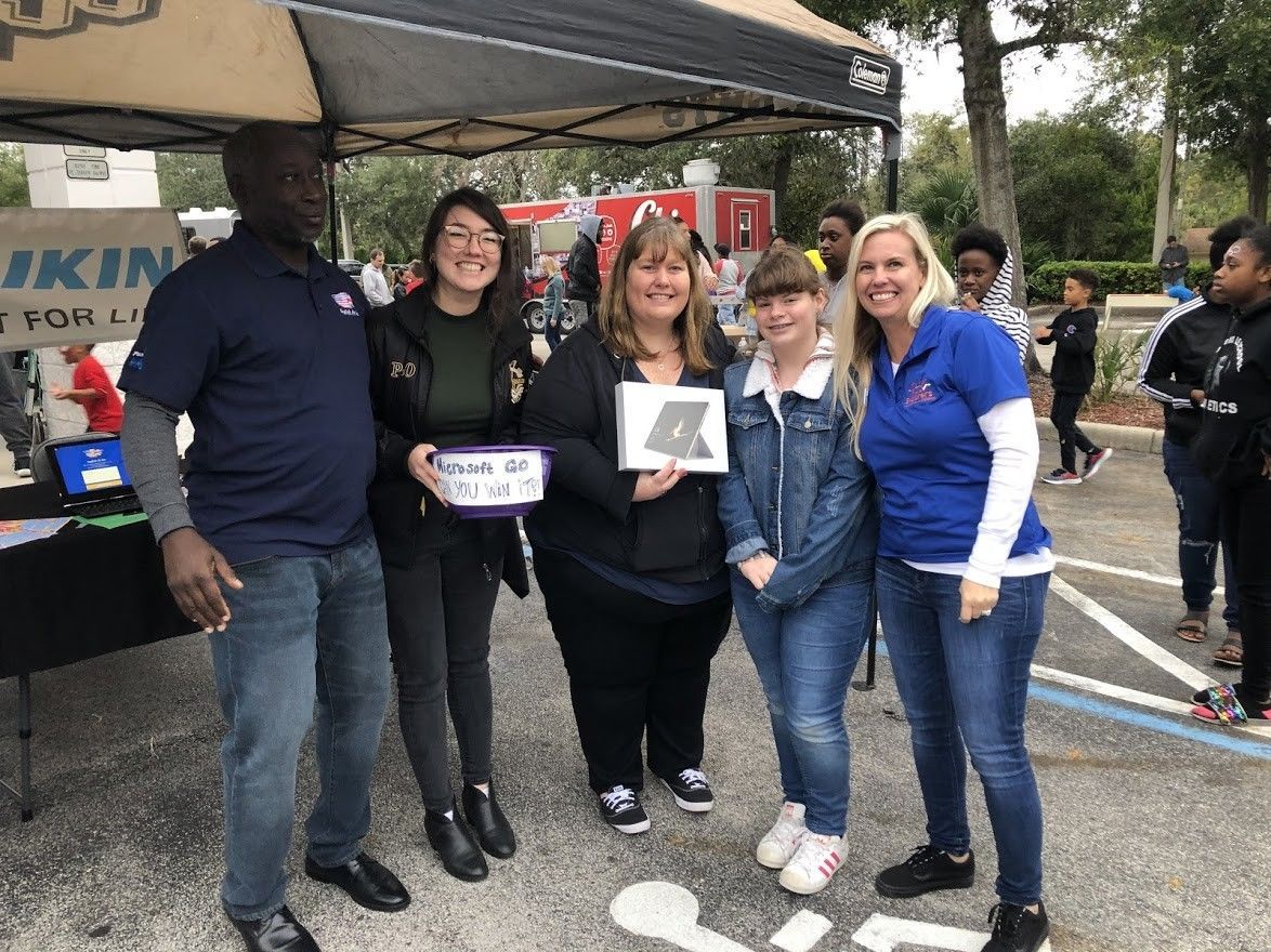 A group of people are posing for a picture in front of a tent.