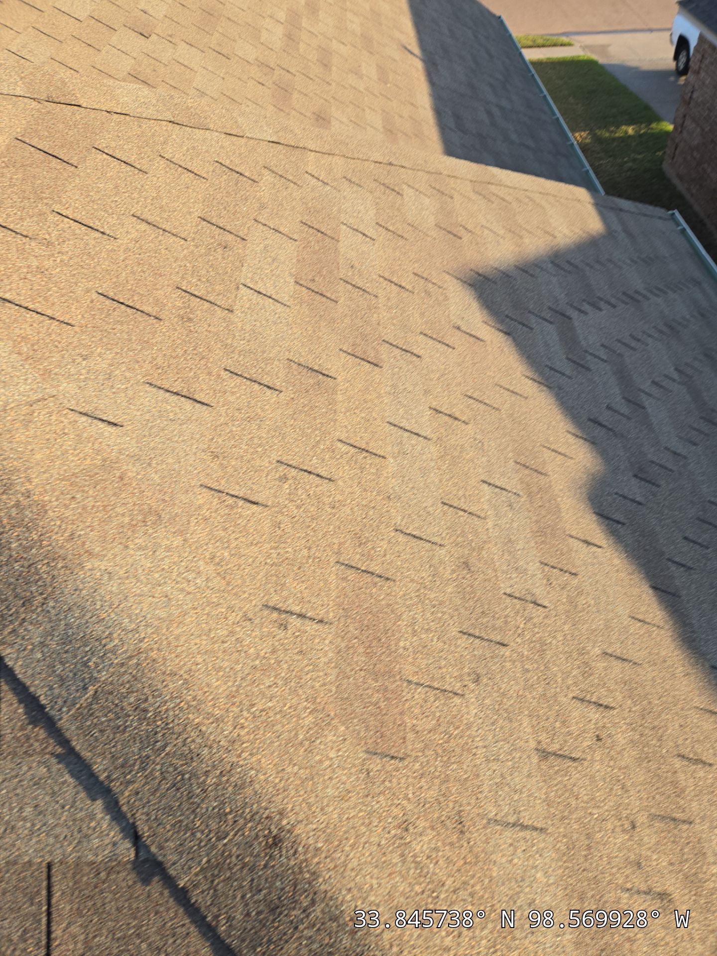 A close up of a roof with a truck parked in the background.