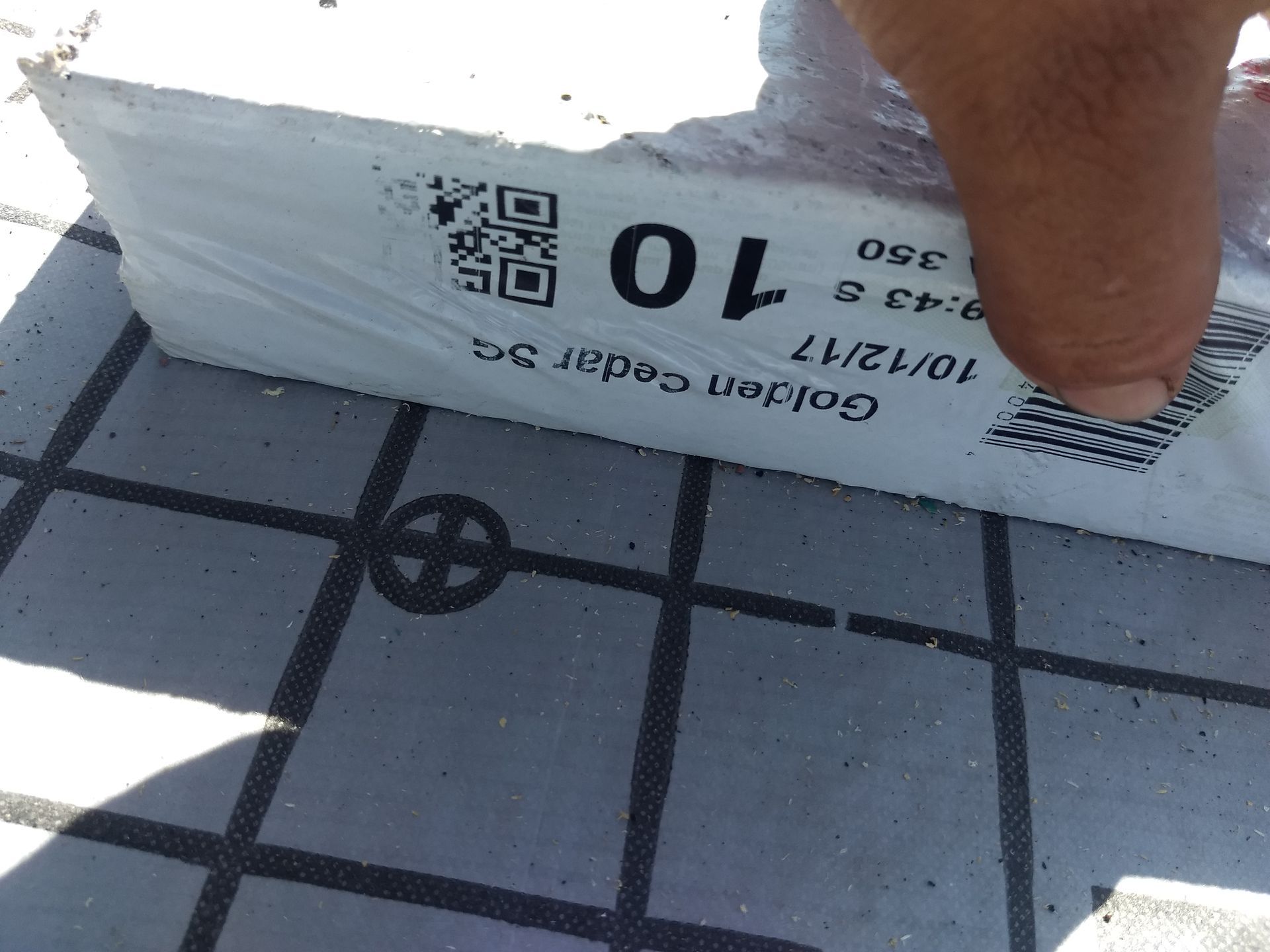 A person is holding a box with the number 10 on it