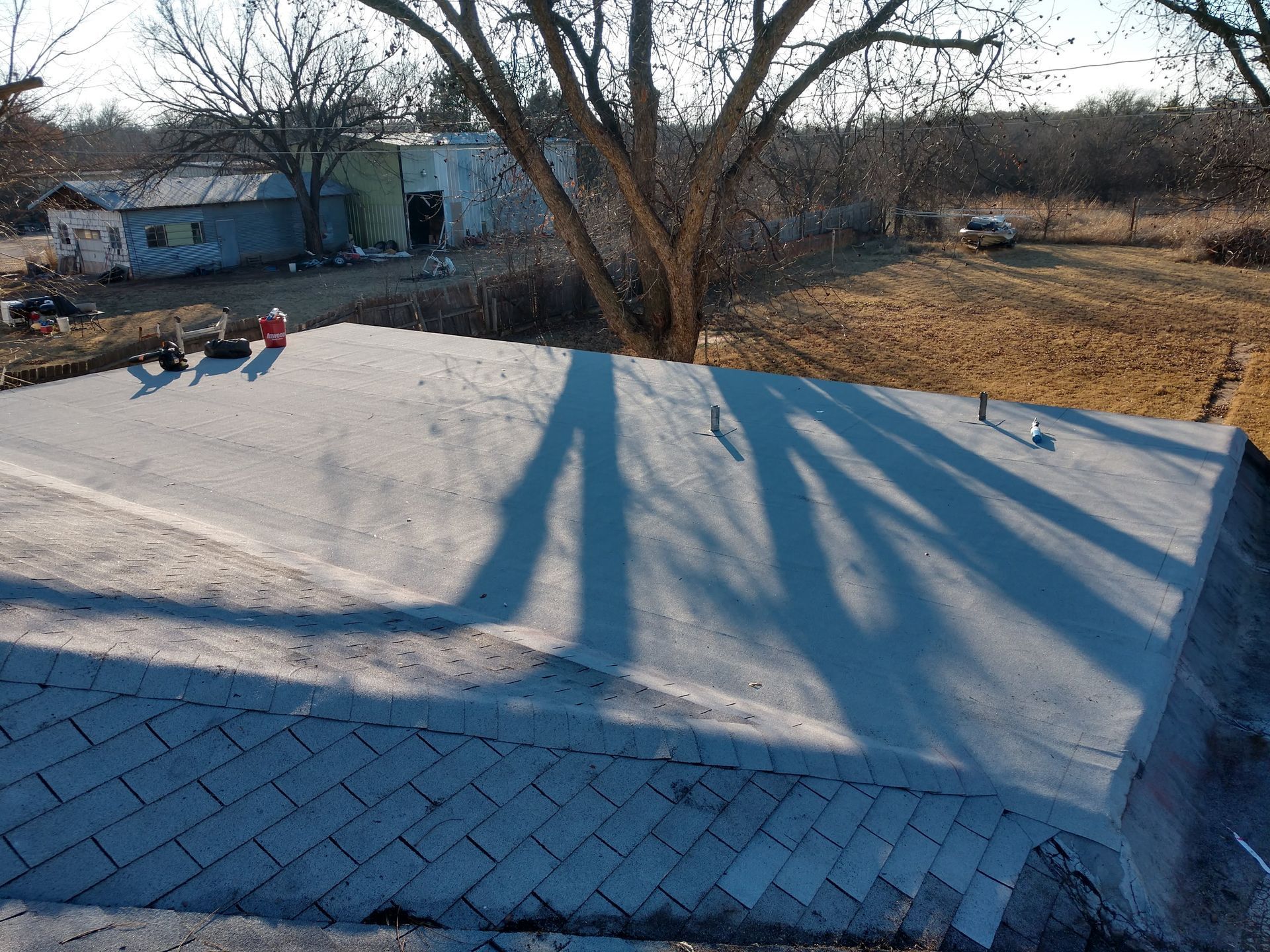 A roof with a shadow of a tree on it