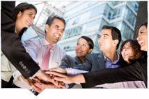 Group of business people huddling
