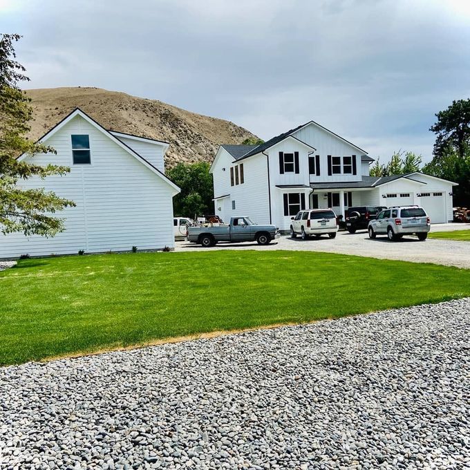 A white house with cars parked in front of it