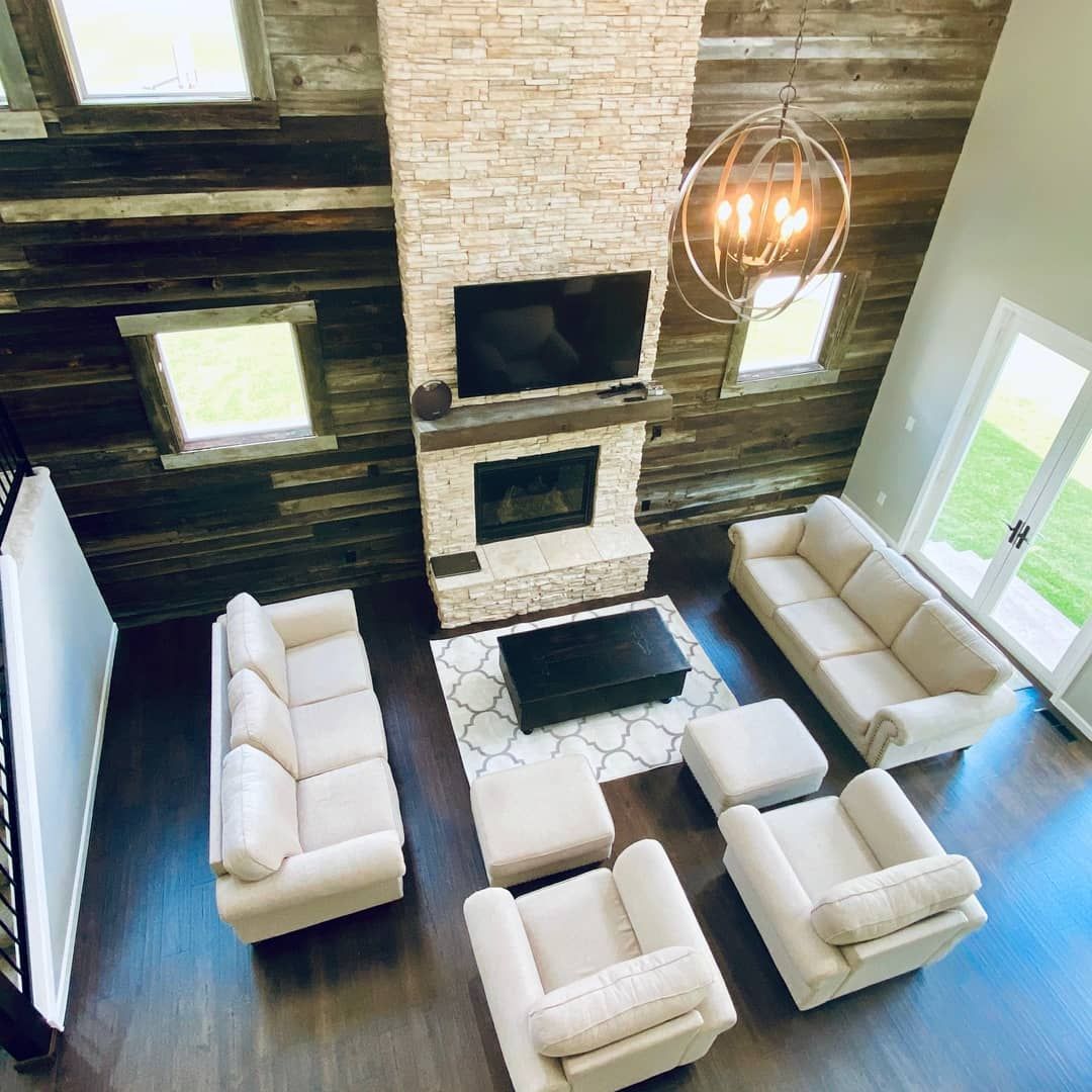 An aerial view of a living room filled with furniture and a fireplace.