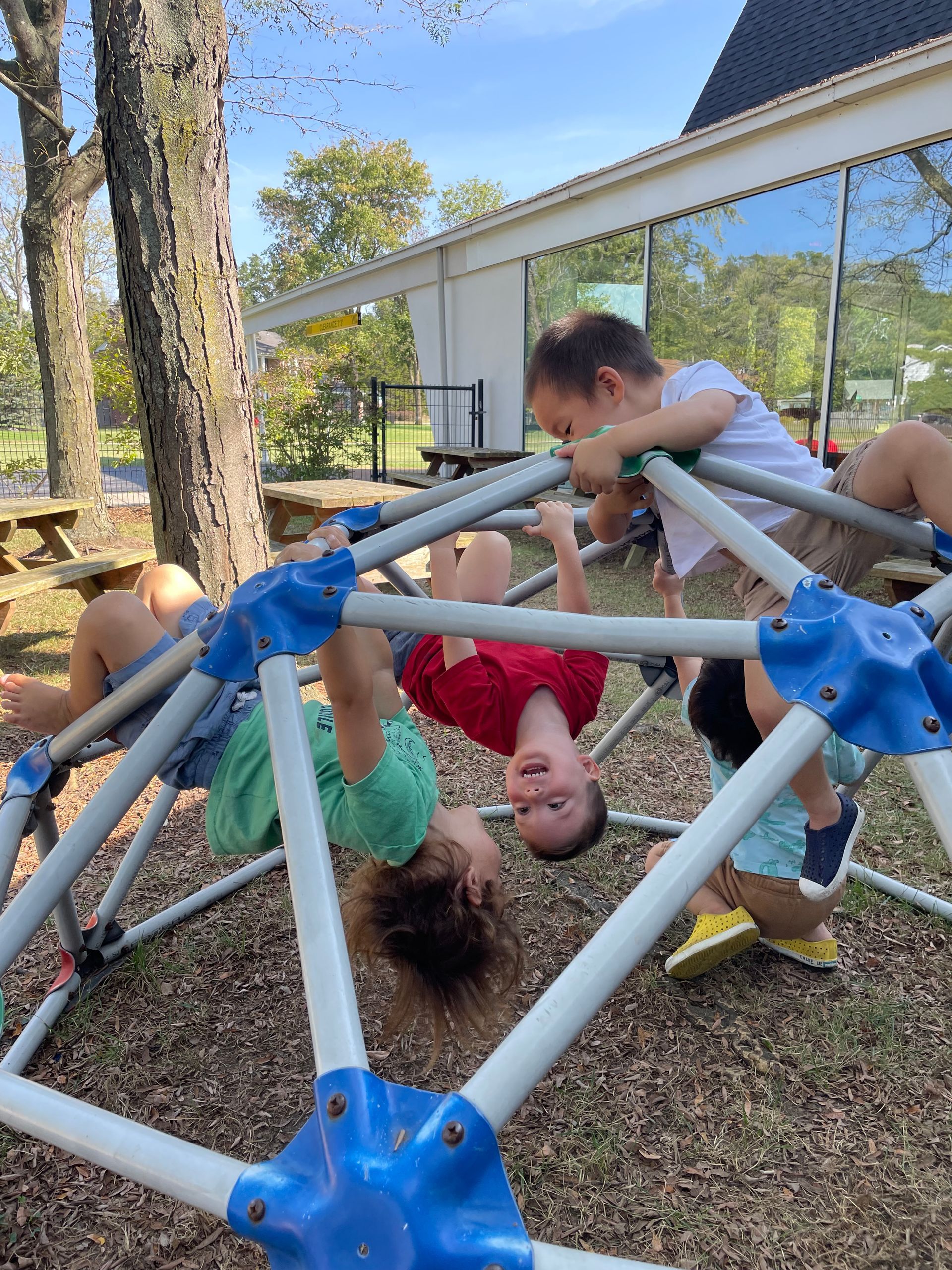 Toddler children play and laugh on the playground.