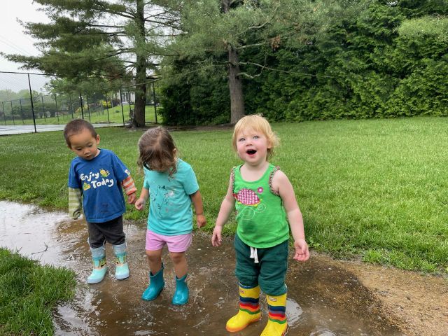 Montessori children happily playing outside at school.