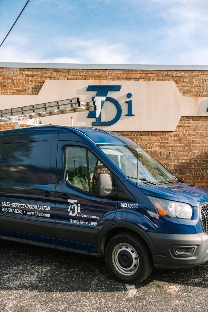 Blue van parked in front of a building with 