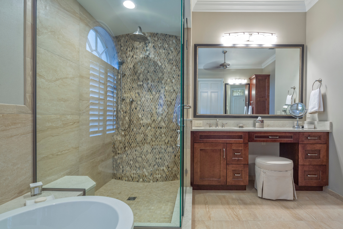 A bathroom with a tub , sink , mirror and walk in shower.