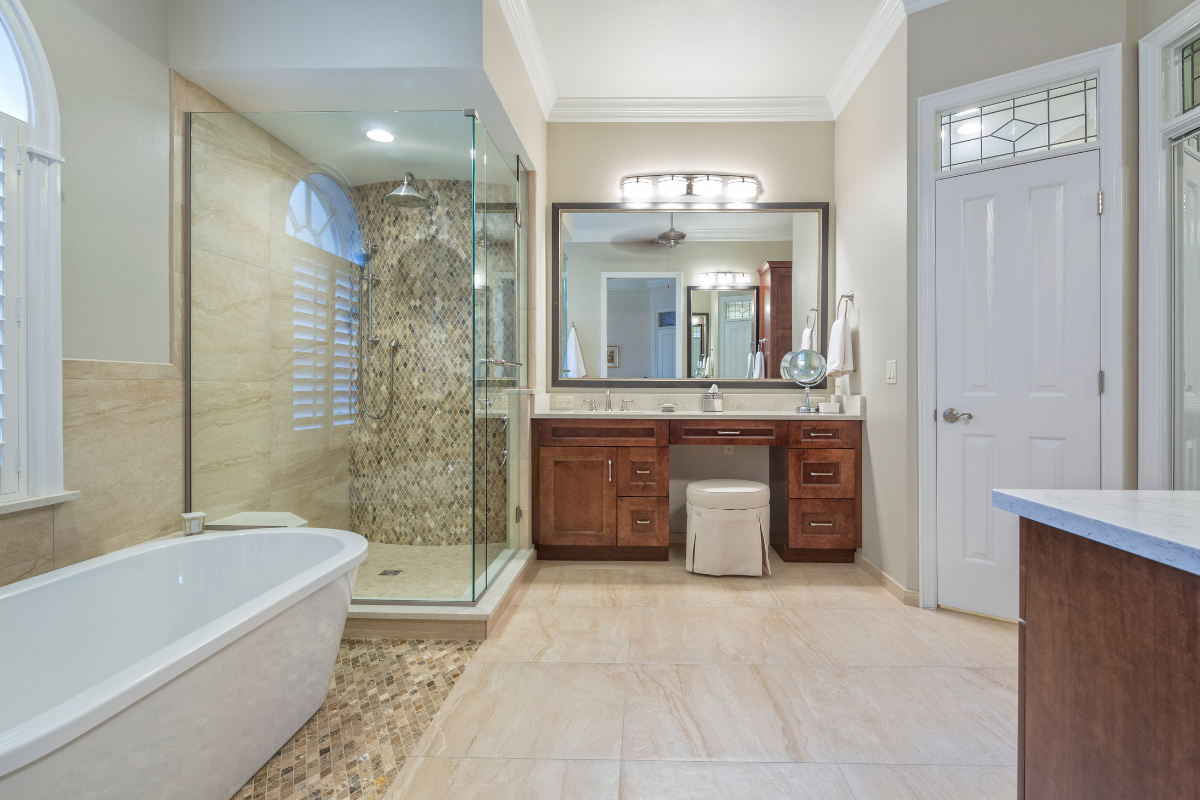 A newly remodeled bathroom with a tub, sink, mirror, and walk-in shower.