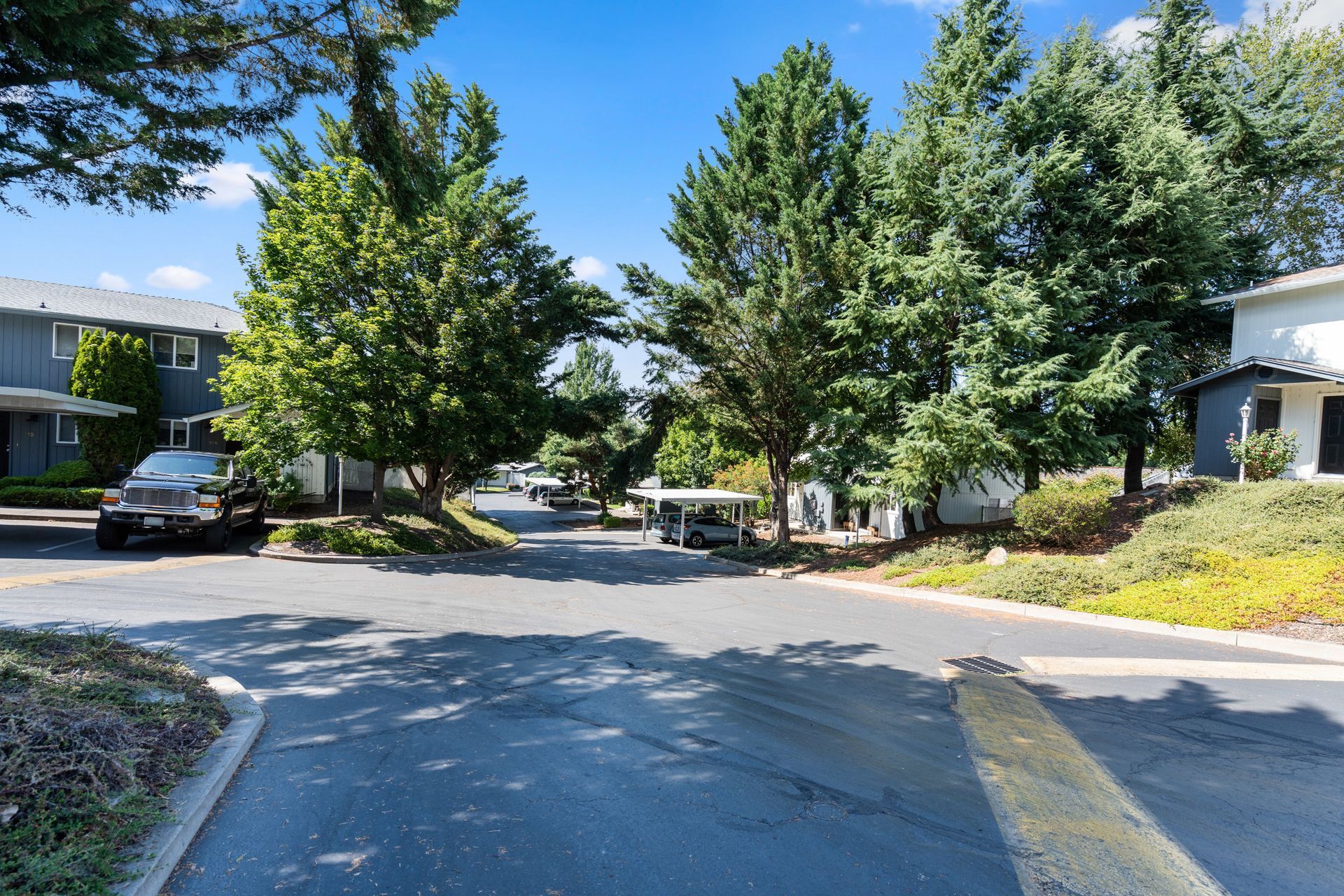 A car is parked on the side of the road in front of a building.