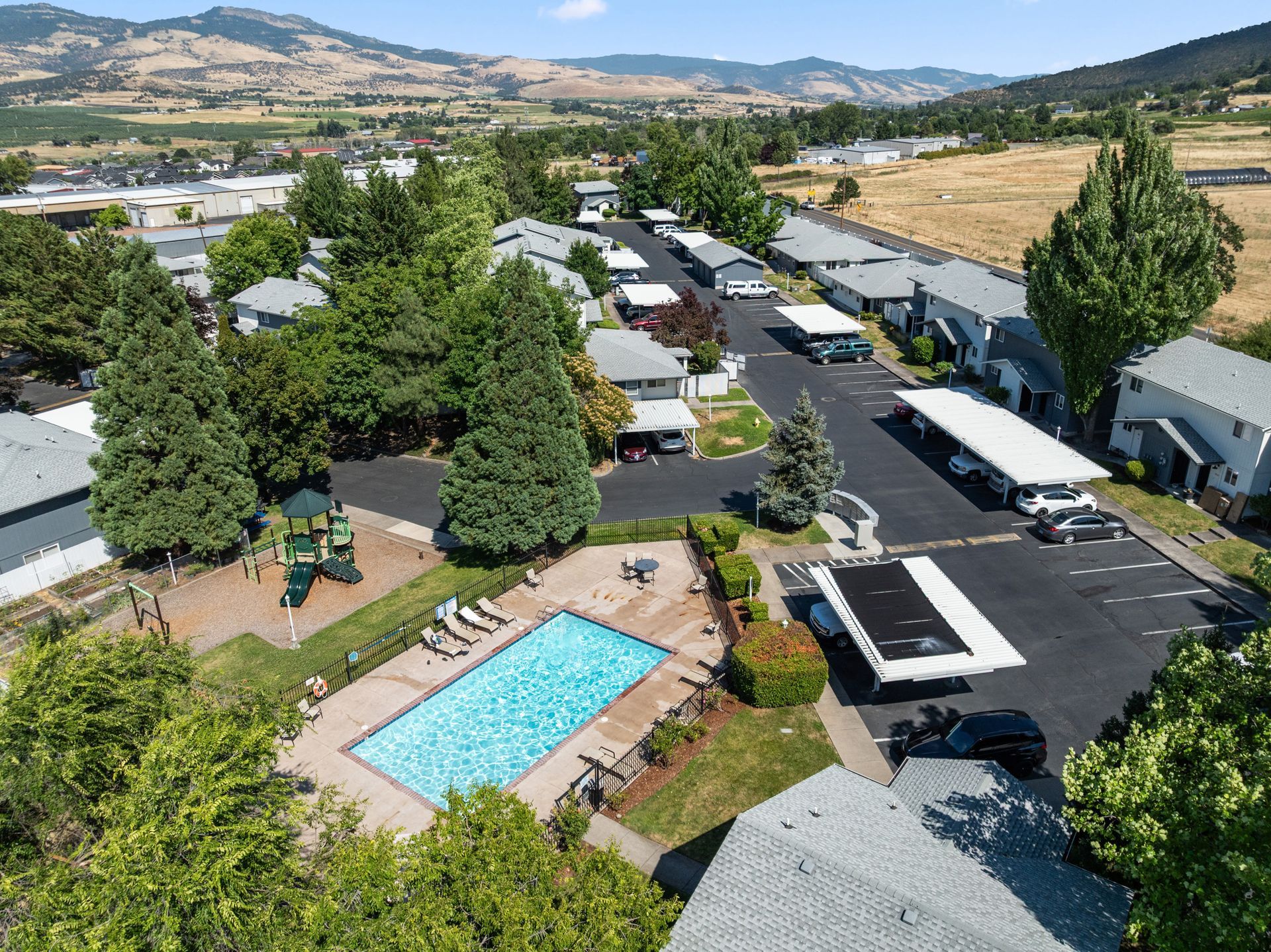 An aerial view of a residential area with a swimming pool