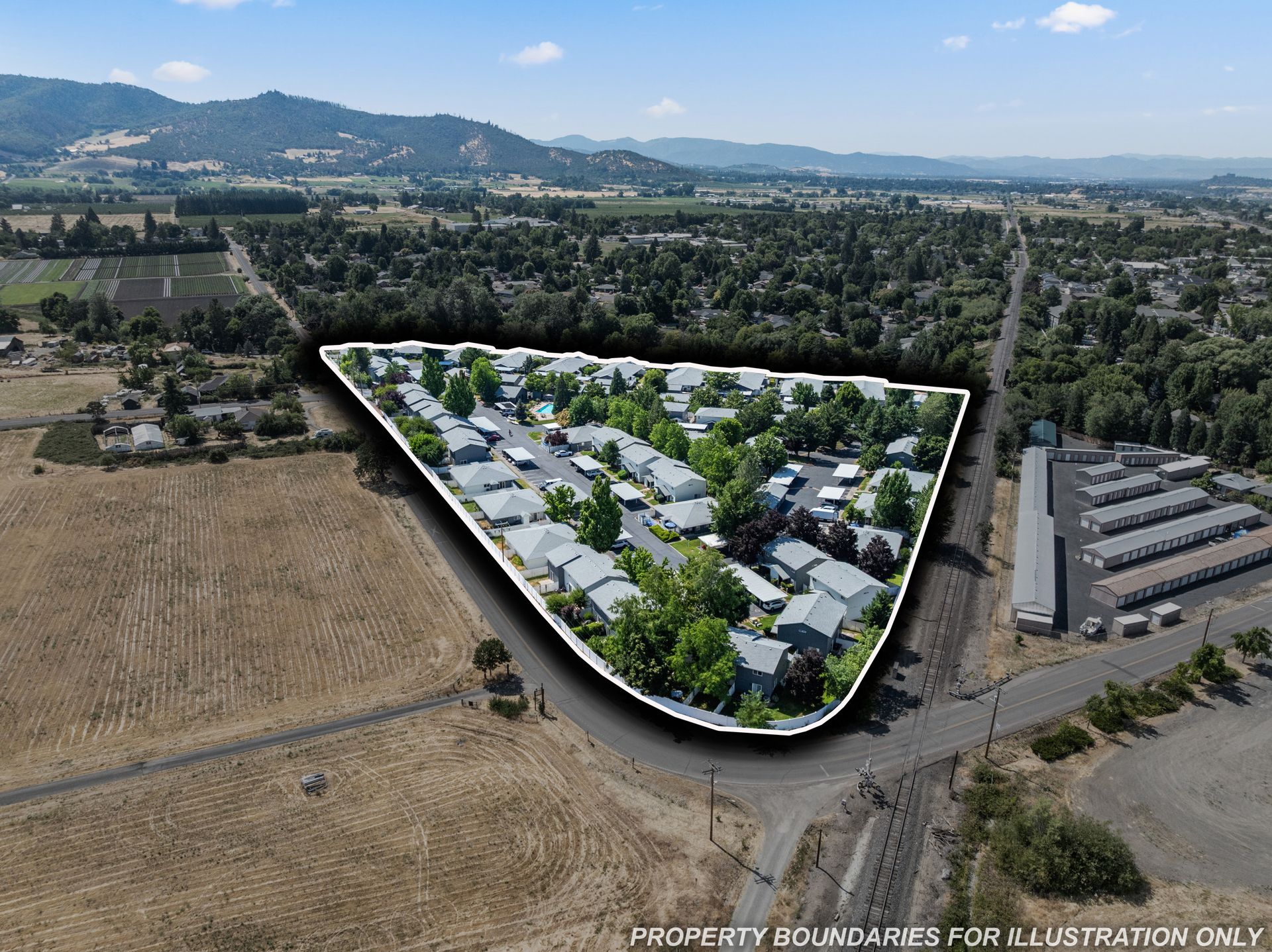 An aerial view of a residential area with mountains in the background
