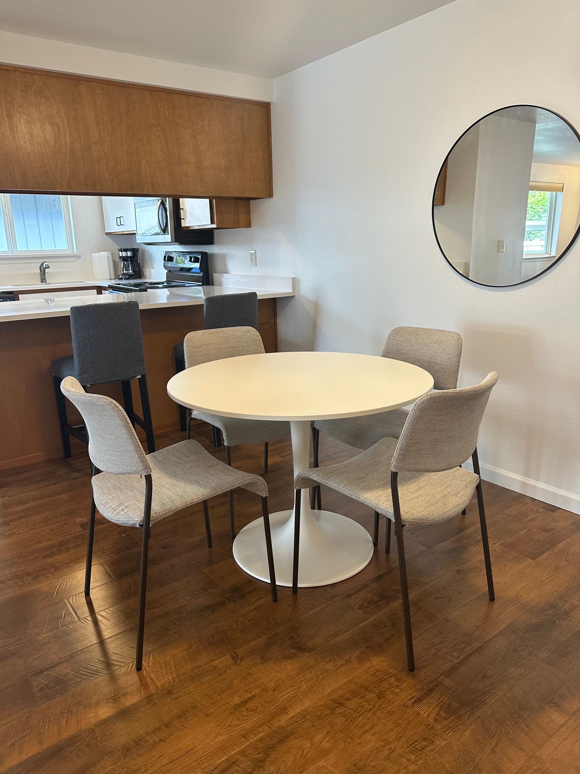 A dining room with a round table and chairs