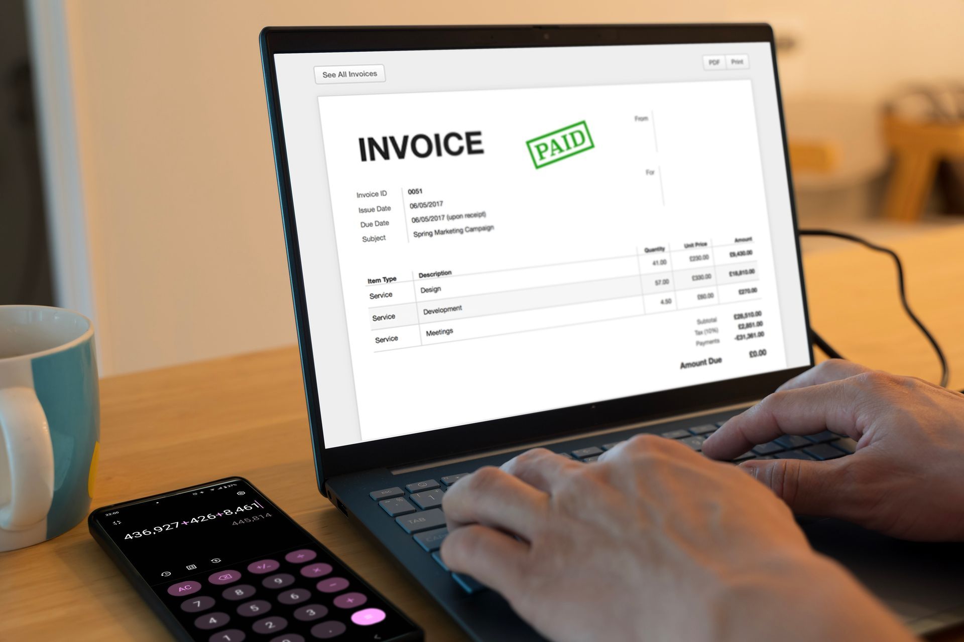 Person typing on a laptop with a 