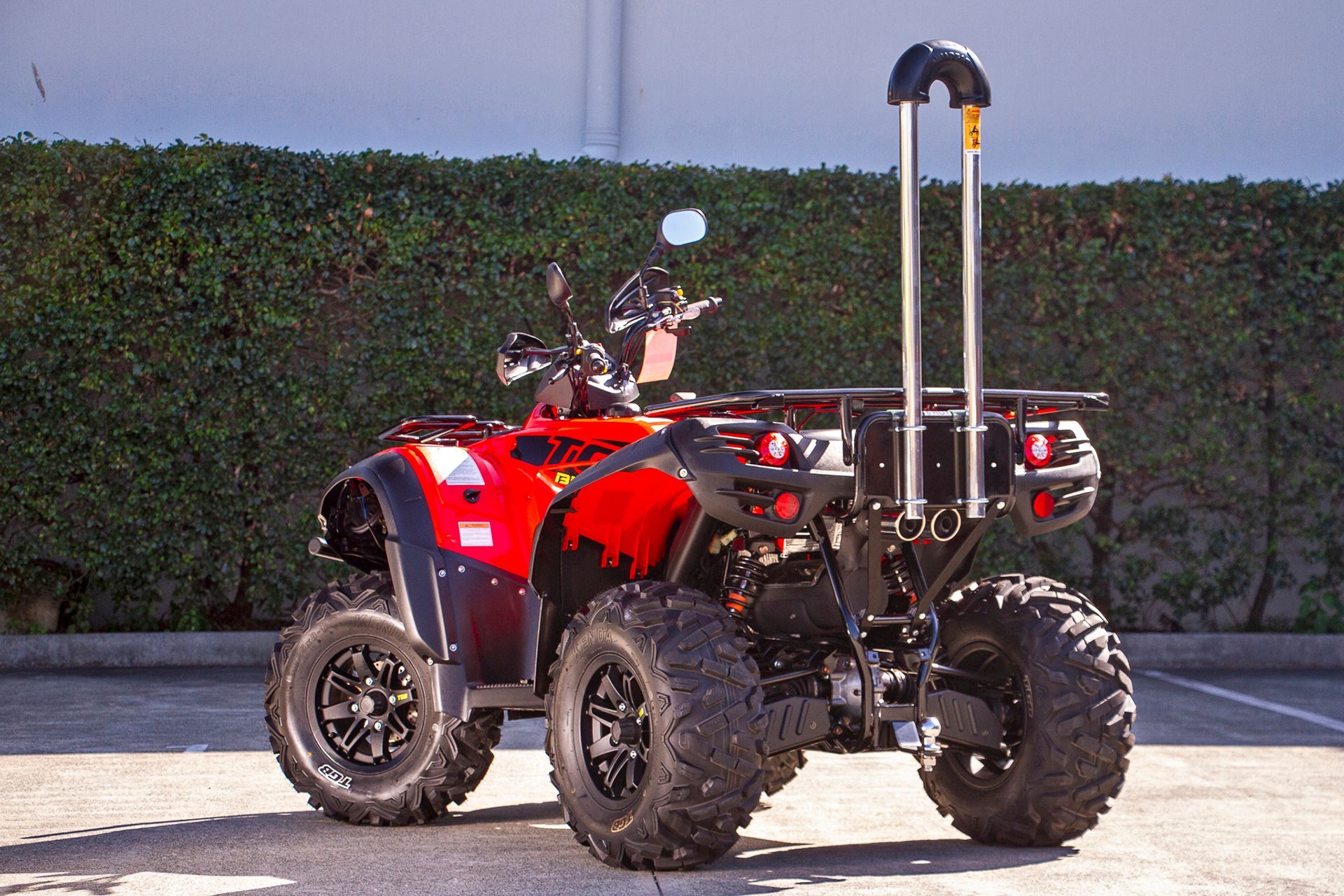 A Red and Black ATV is Parked in a Parking Lot — MPE Adventure Quads & Bikes In Thornton, NSW