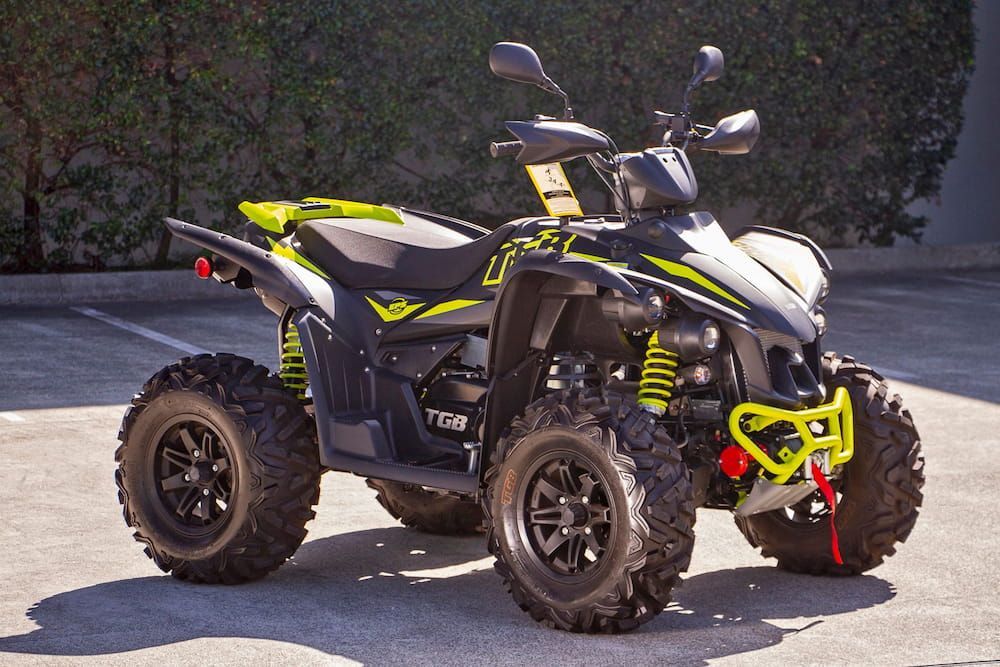 A Black and Yellow ATV is Parked in a Parking Lot — MPE Adventure Quads & Bikes In Taree, NSW