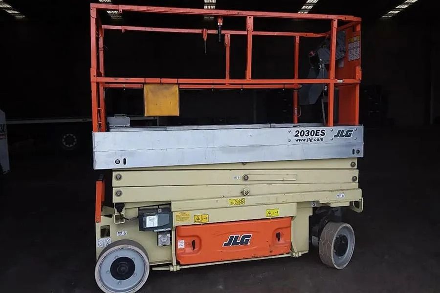 A JLG Scissor Lift is Parked in a Garage — MPE Adventure Quads & Bikes In Thornton, NSW