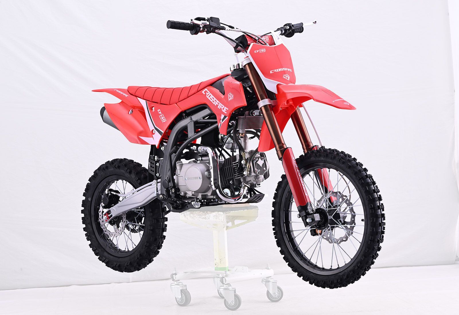 Red Dirt Bike on a Stand With a White Background — MPE Adventure Quads & Bikes In Thornton, NSW