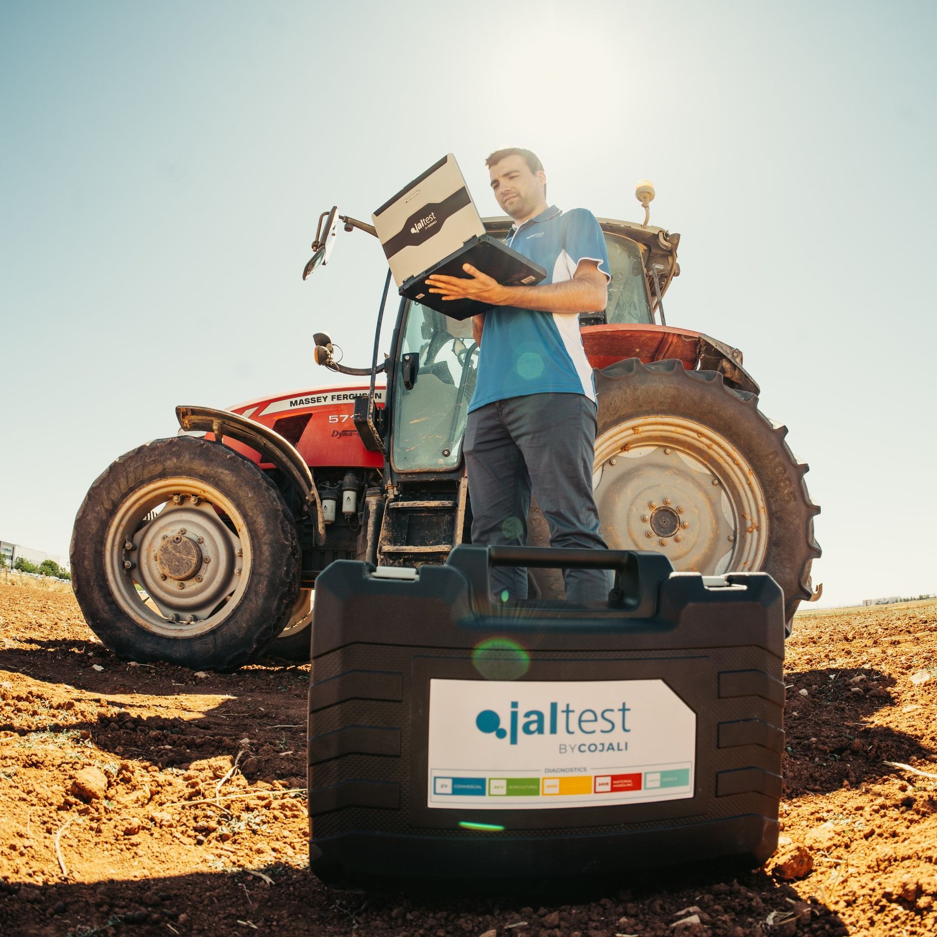 A Man is Working on a Car With a Scanner — MPE Adventure Quads & Bikes In Thornton, NSW