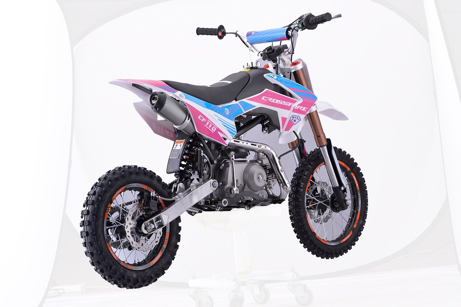 A Pink and Blue Dirt Bike is Sitting on a White Surface — MPE Adventure Quads & Bikes In Thornton, NSW