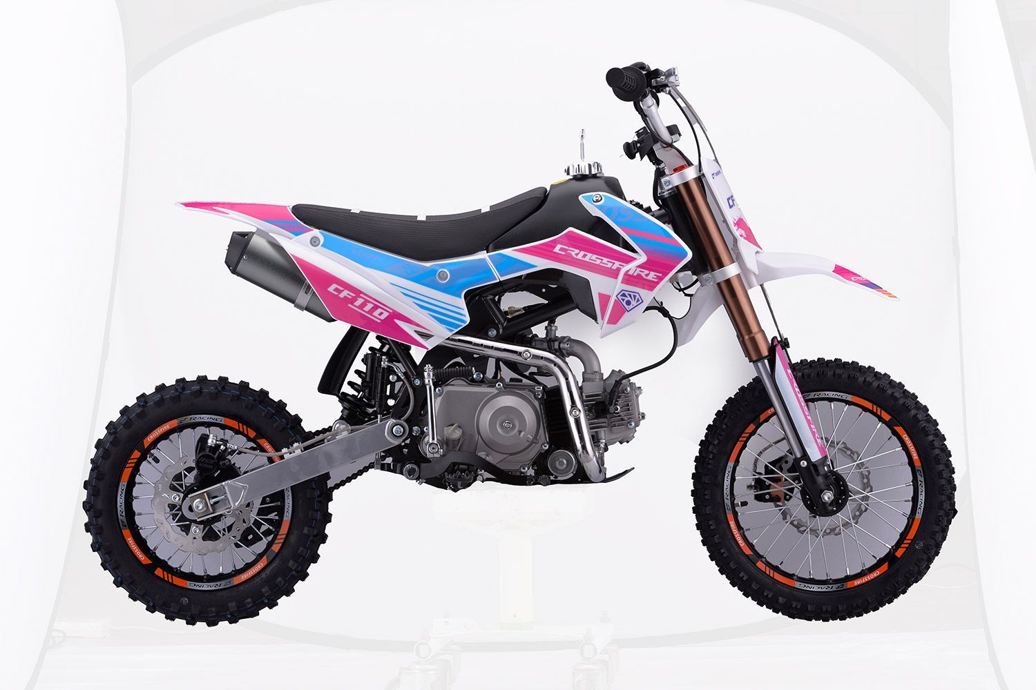 A Pink and Blue Dirt Bike is Sitting on a White Surface — MPE Adventure Quads & Bikes In Thornton, NSW