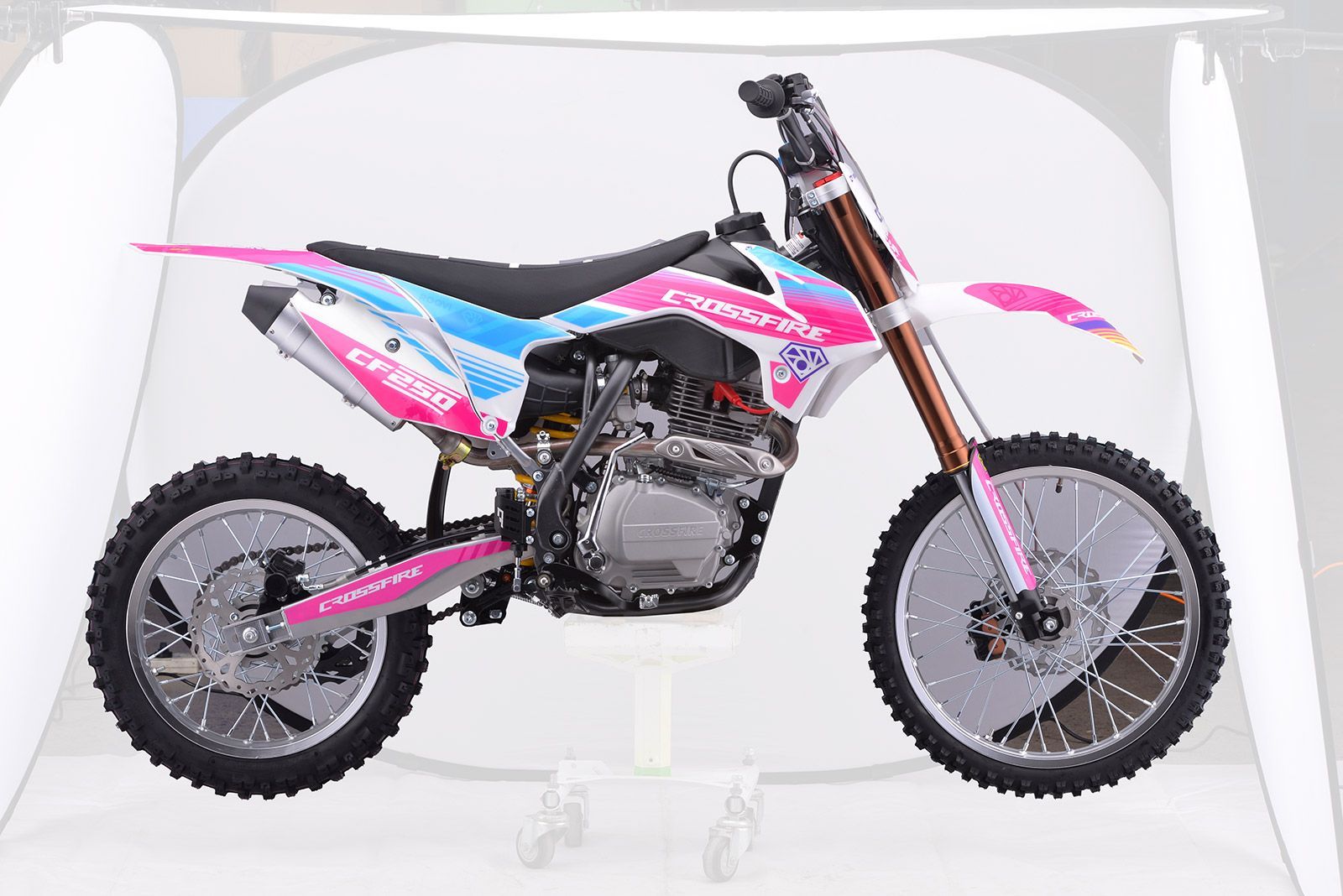 A Red and Blue Dirt Bike is on a White Background — MPE Adventure Quads & Bikes In Thornton, NSW