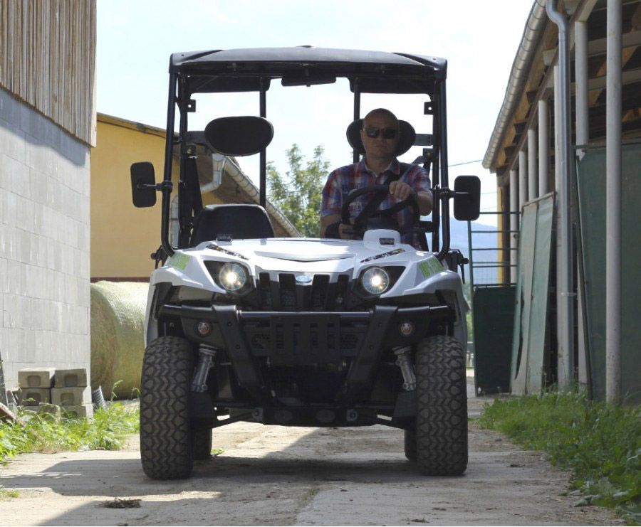 A Man is Driving a Buggy Down a Dirt road — MPE Adventure Quads & Bikes In Port Stephens, NSW