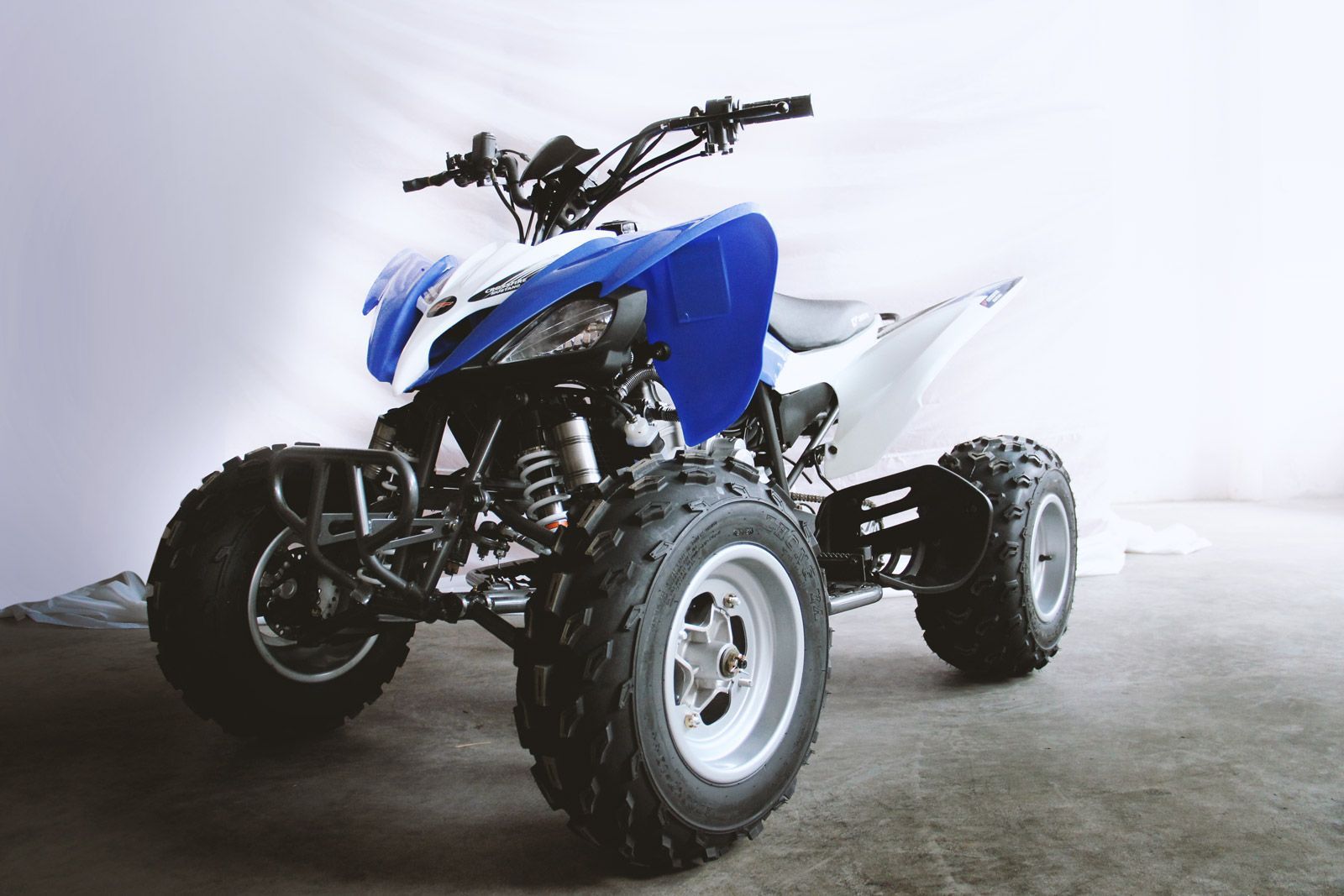 A Blue and White Atv on a White Background — MPE Adventure Quads & Bikes In Thornton, NSW