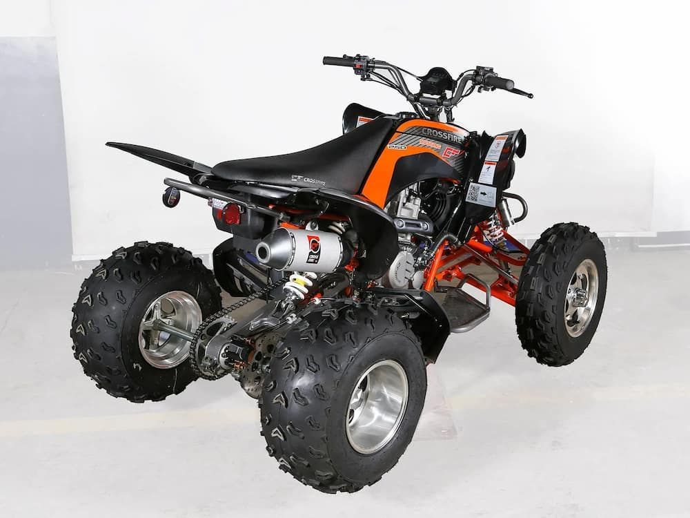 An Orange and Black Atv is Sitting on a White Surface — MPE Adventure Quads & Bikes In Thornton, NSW
