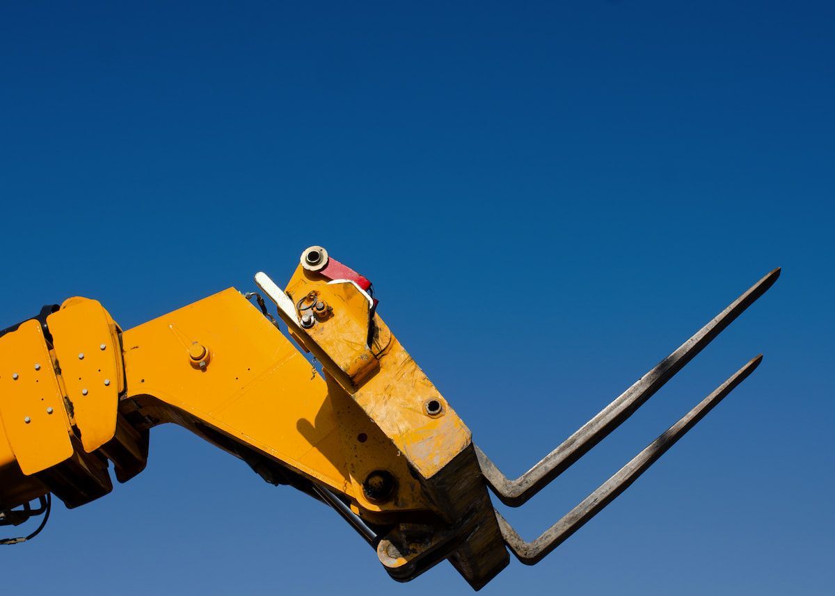 A Close Up of a Yellow Forklift Against a Blue Sky — MPE Adventure Quads & Bikes In Lake Macquarie, NSW