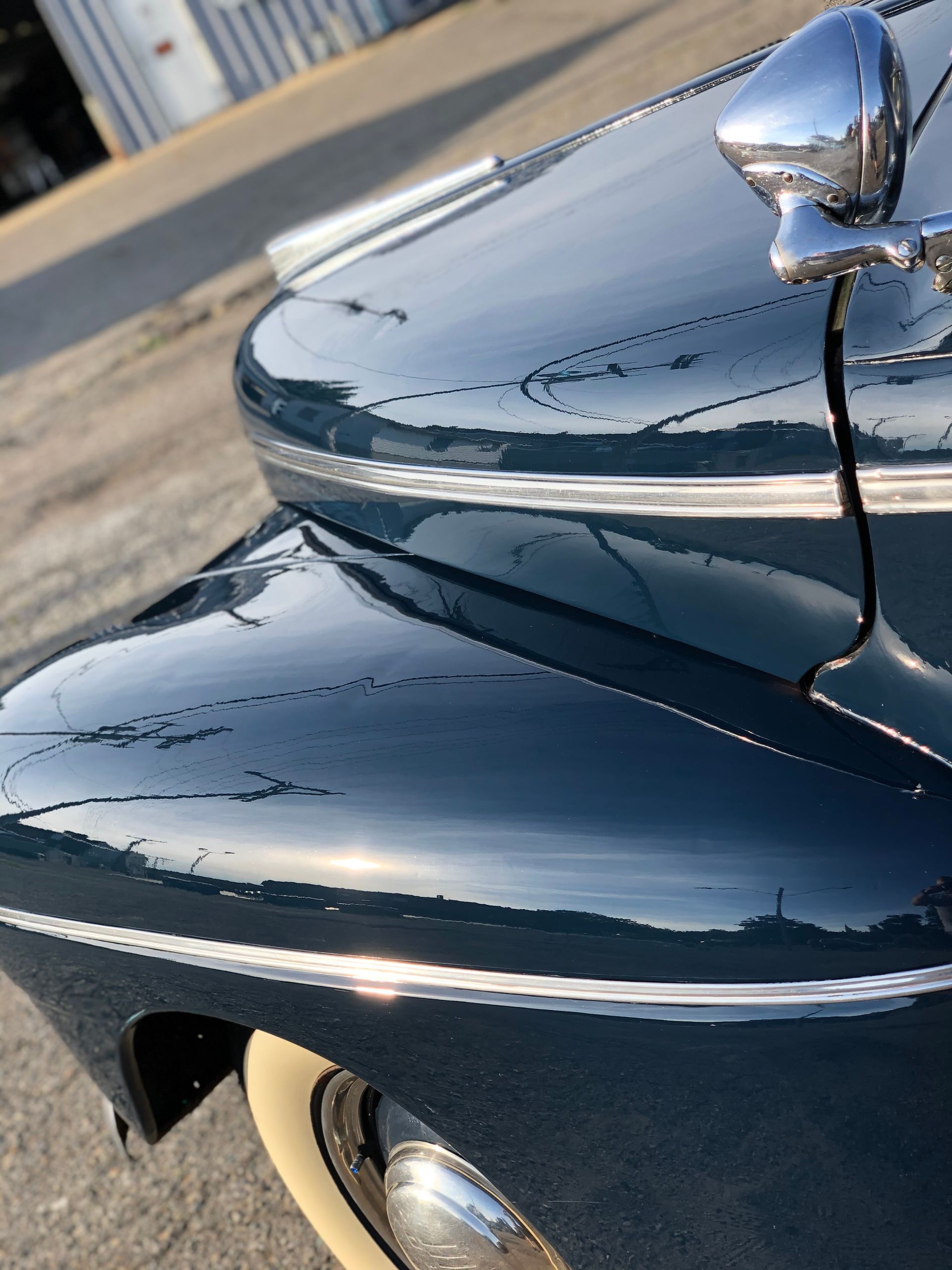 A close up of the hood of a black car