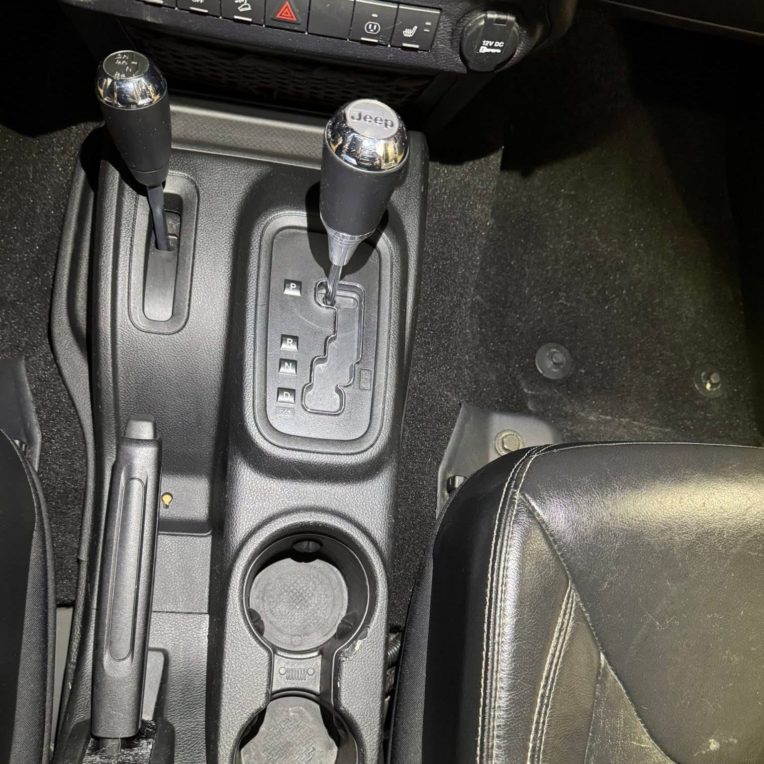 The back seat of a car with black leather seats.