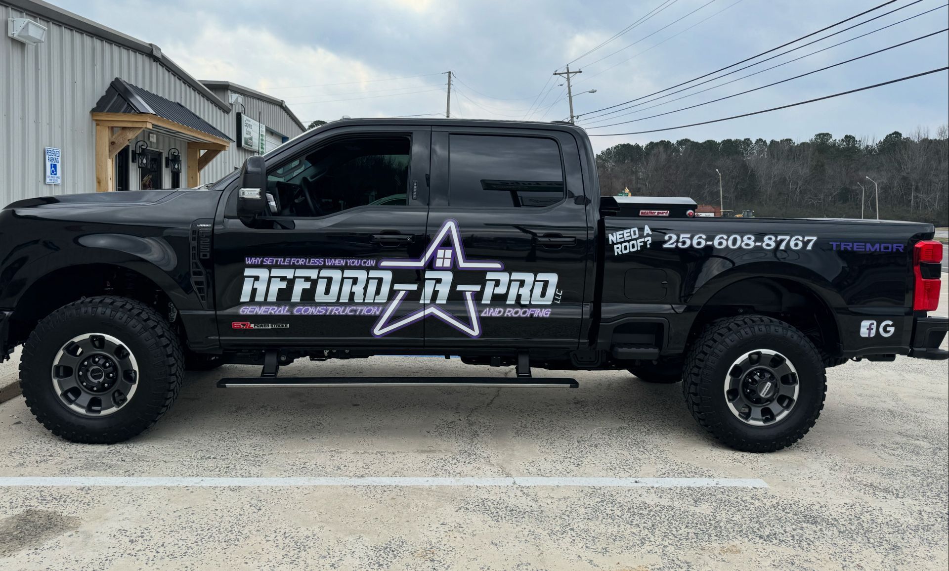 A roof with weathered shingles, a triangular vent, and clear blue sky.